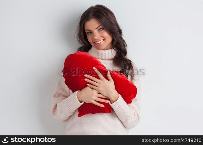 Woman with pillow heart. Beautiful woman with red pillow heart, valentine&rsquo;s day concept