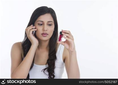 Woman with pills talking on mobile phone