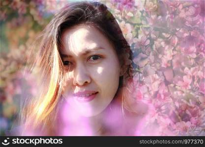 Woman with pink flowers blooming Double Exposure