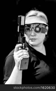 Woman with pistol on sport shooting training