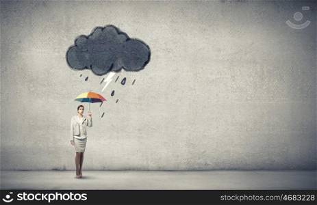 Woman with rainbow umbrella. Young businesswoman with colorful umbrella under black cloud