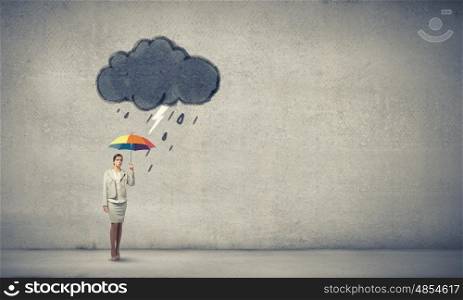 Woman with rainbow umbrella. Young businesswoman with colorful umbrella under black cloud