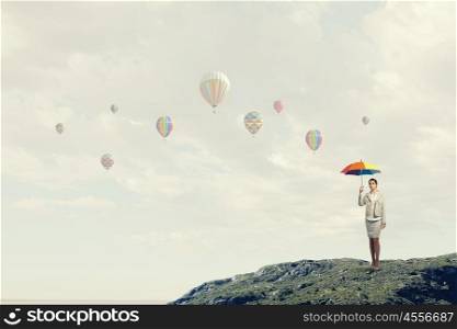 Woman with rainbow umbrella. Young pretty businesswoman with rainbow colorful umbrella