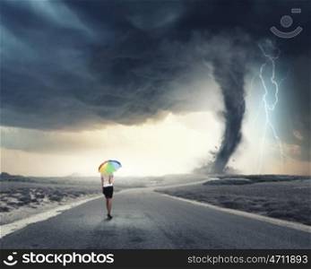 Woman with rainbow umbrella. Young pretty businesswoman with rainbow colorful umbrella walking in storm
