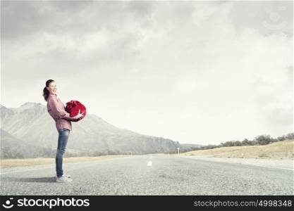 Woman with red bag. Young girl with red santa bag in hands