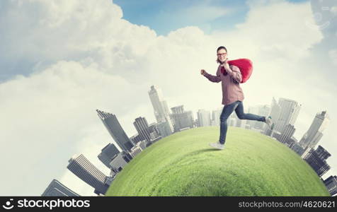 Woman with red bag. Young running girl with red santa bag in hands