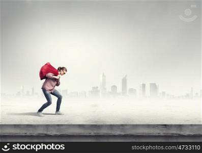 Woman with red bag. Young running girl with red santa bag in hands