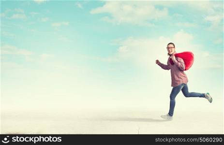 Woman with red bag. Young running girl with red santa bag in hands