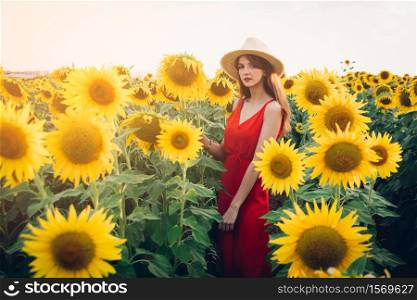 woman with red dress in sunflower field.. woman with red dress in sunflower field