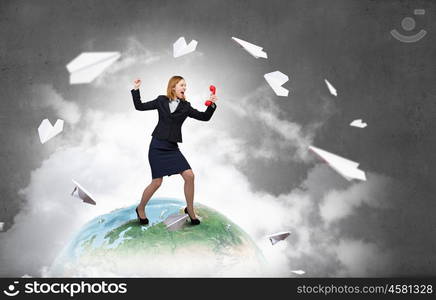 Woman with red handset. Young businesswoman with red phone receiver in hands. Elements of this image are furnished by NASA