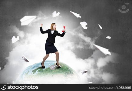 Woman with red handset. Young businesswoman with red phone receiver in hands. Elements of this image are furnished by NASA