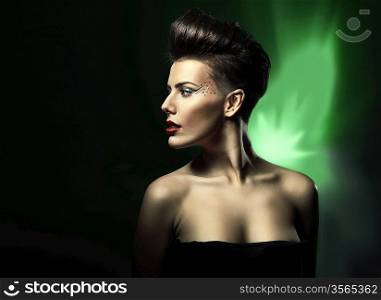 woman with red lips in black dress in dark green light