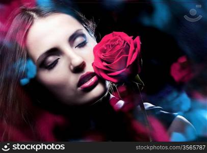 woman with red rose and blue lights
