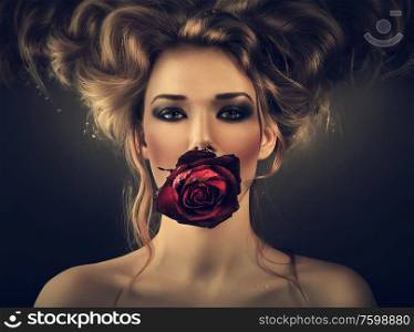 woman with red rose and drops in hair in dark