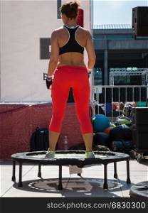 Woman with Red Sportswear having Exercise on Rebounder