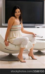 Woman with Remote Control next to Big Screen Television