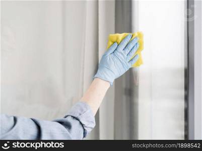 woman with rubber glove wiping window. Resolution and high quality beautiful photo. woman with rubber glove wiping window. High quality beautiful photo concept