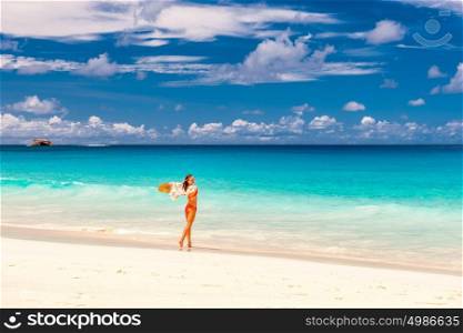 Woman with sarong on beach Anse Intendance at Seychelles, Mahe