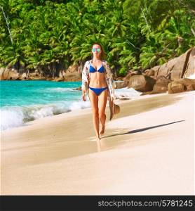 Woman with sarong on beach Anse Intendance at Seychelles, Mahe