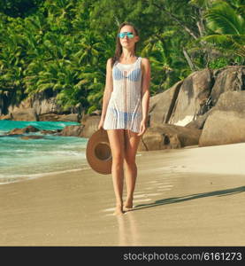 Woman with sarong on beach Anse Intendance at Seychelles, Mahe