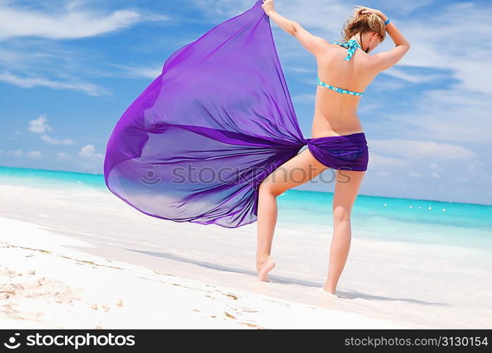 Woman with sarong on caribbean beach