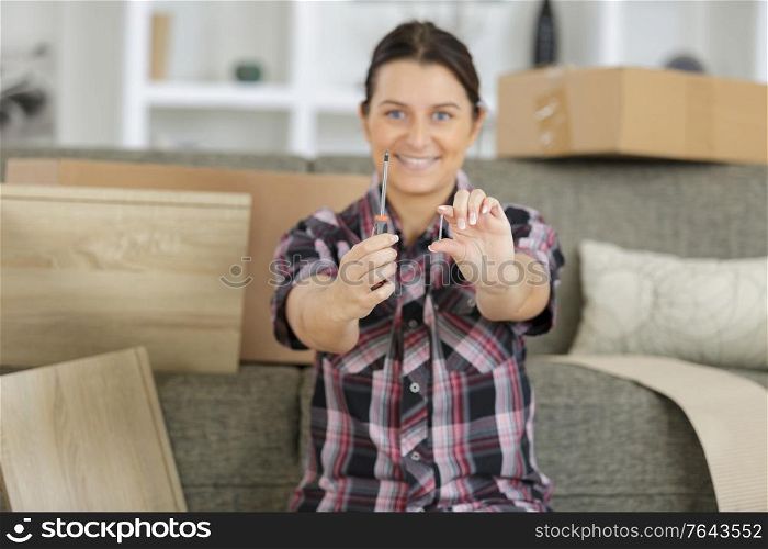 woman with self assembly furniture in kitchen