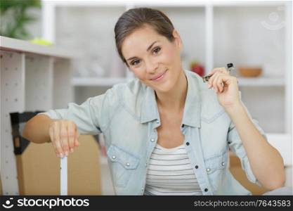 woman with self assembly furniture in kitchen