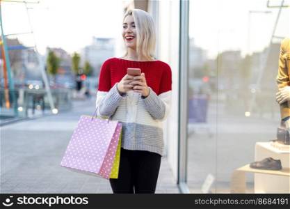Woman with shopping bags and cellphone