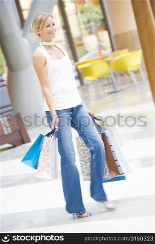 Woman with shopping bags at a shopping mall