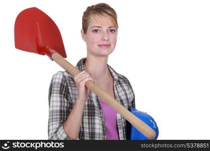 Woman with shovel over her shoulder