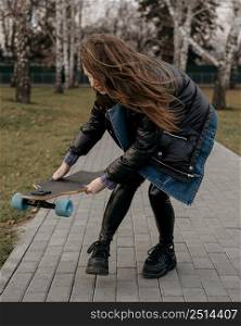 woman with skateboard outdoors