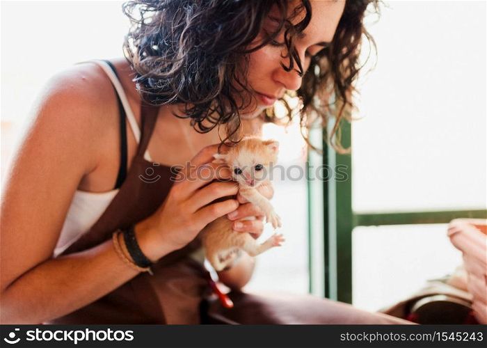 Woman with small kittens inside her store