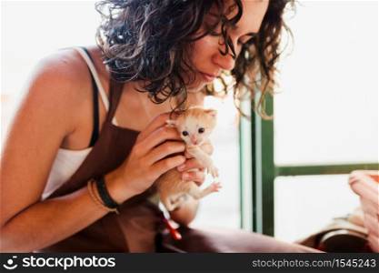 Woman with small kittens inside her store