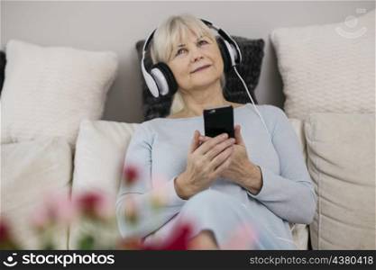 woman with smartphone listening music