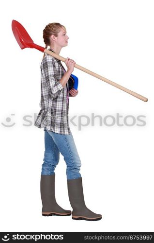 Woman with spade and hard hat