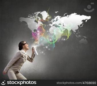 Woman with spray can. Young woman in suit and glasses spraying world map