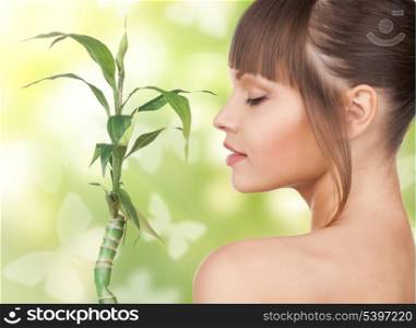 woman with sprout and butterflies over green background