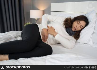woman with stomach ache in a bed
