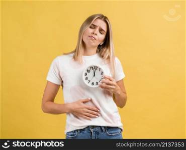woman with stomachache clock