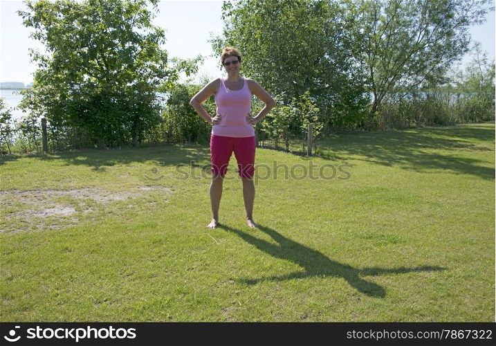 woman with strange shadow on the green grass