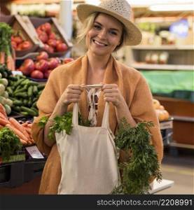 woman with summer hat groceries smiles