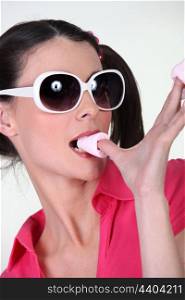 Woman with sunglasses eating sweets