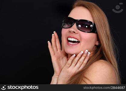 woman with sunglasses looking ecstatic