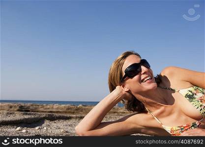 Woman With Sunglasses Relaxing On Beach