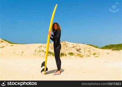 woman with surfing board is standing on a beach, Peniche, Portugal