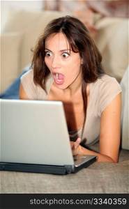 Woman with surprised look in front of computer