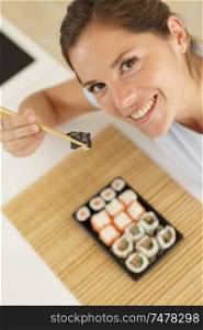 woman with sushi hold philadelphia rolls in hands