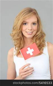 Woman with Swiss flag on gray background
