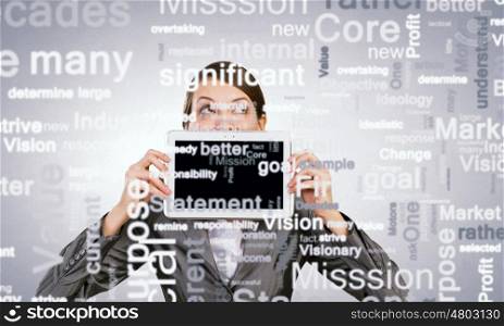 Woman with tablet. Beautiful young woman holding tablet pc against her mouth