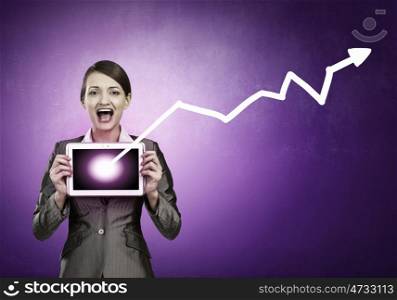 Woman with tablet. Beautiful young woman holding tablet pc with graph against her chest